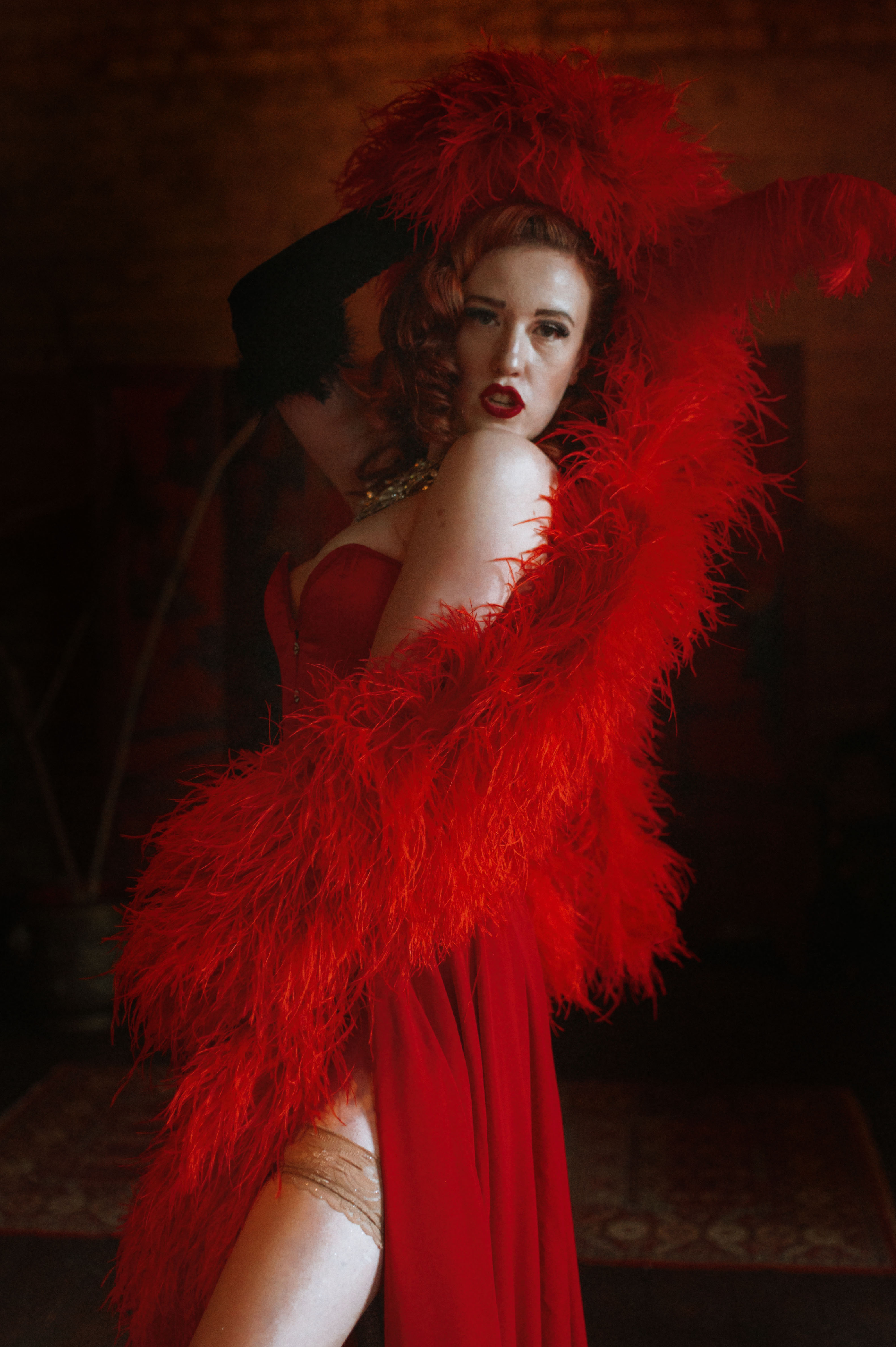 Belle de Beauvoir in a dramatic red feather costume